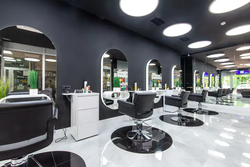 Modern beauty salon with styling chairs and arched mirrors